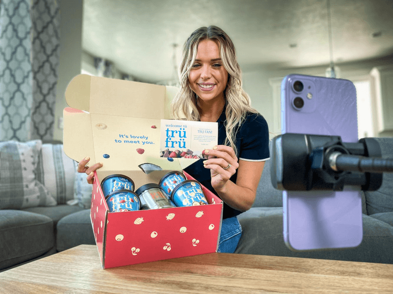 woman unboxing looking at a phone